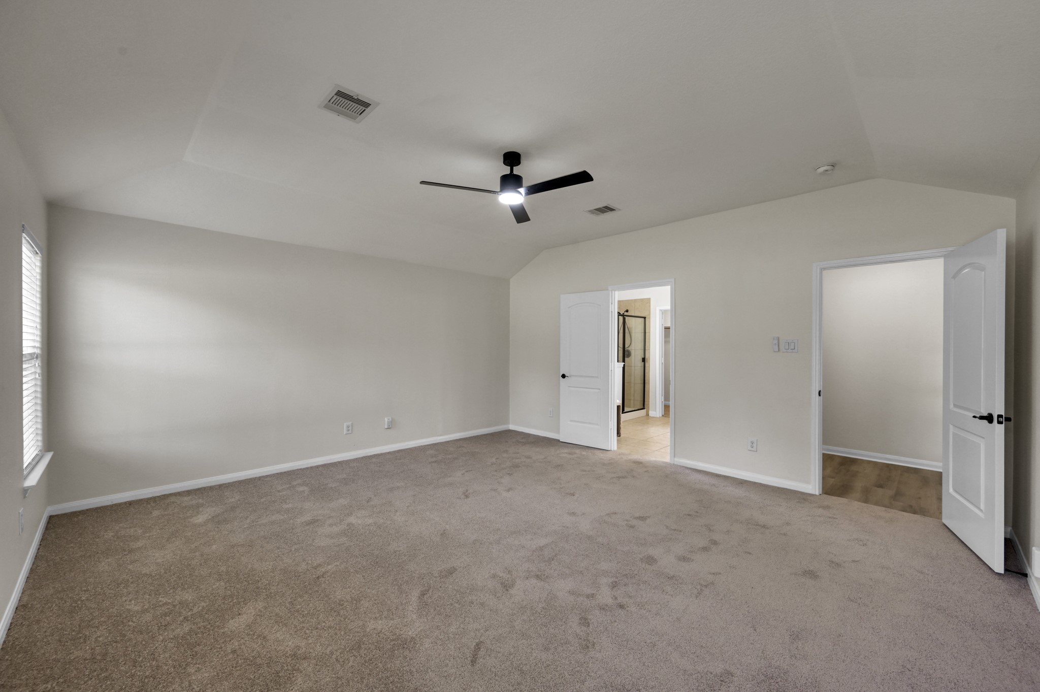 18894 Maverick Ranch Road West Magnolia, TX 77355 - Photo 19 of 43 Primary bedroom with the left door to the Primary Bath. The door on the right leads to the Living room.