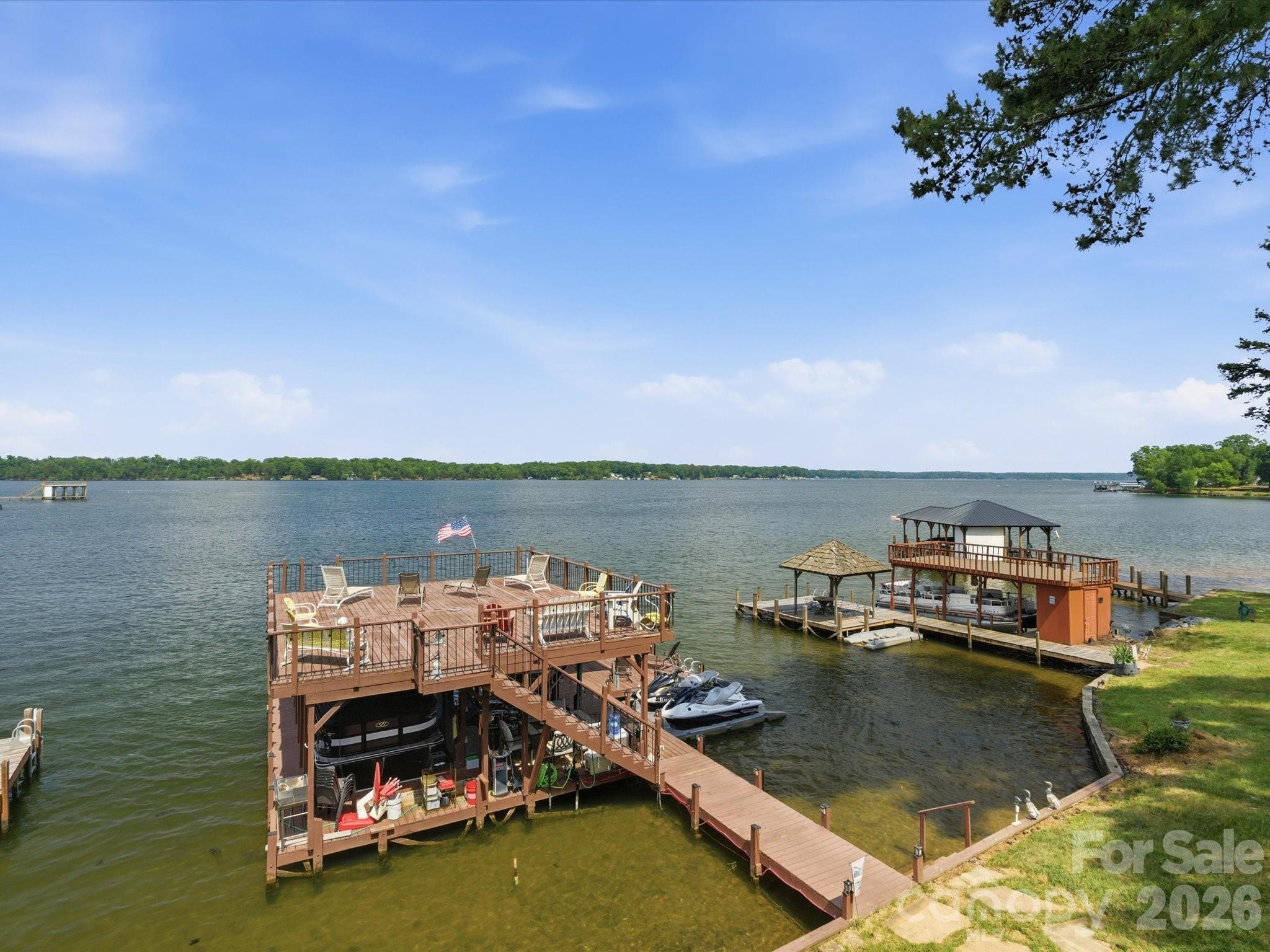 562 Lake Head Road Norwood, NC 28128 - Photo 4 of 43 a view of a lake with boats and trees in the background
