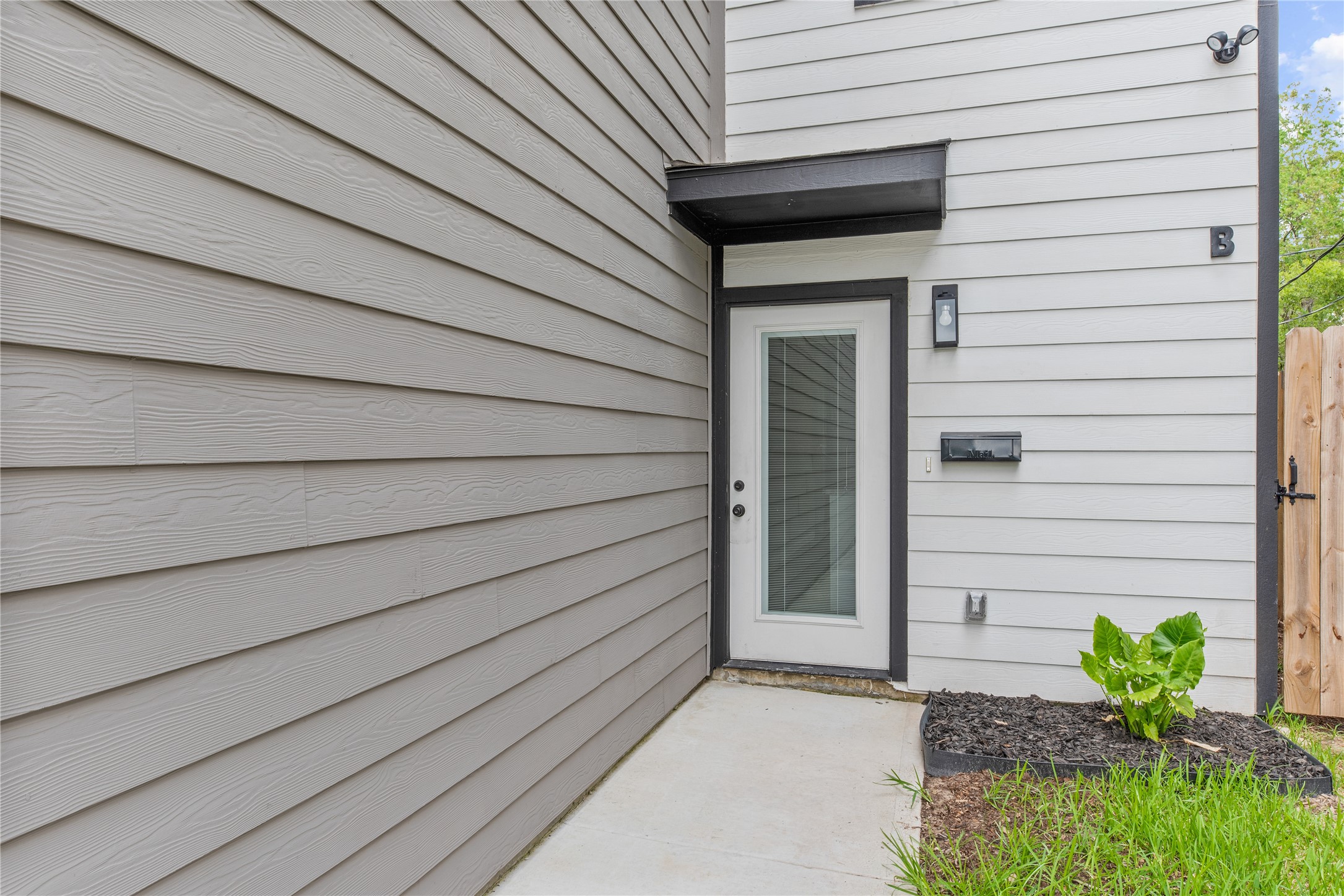 8161 Tate Street, Unit B Houston, TX 77028 - Photo 2 of 20 A contemporary entryway with a stylish door that welcomes you into this modern home.