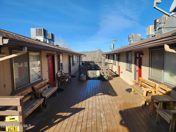 a living room with couches rug and a window