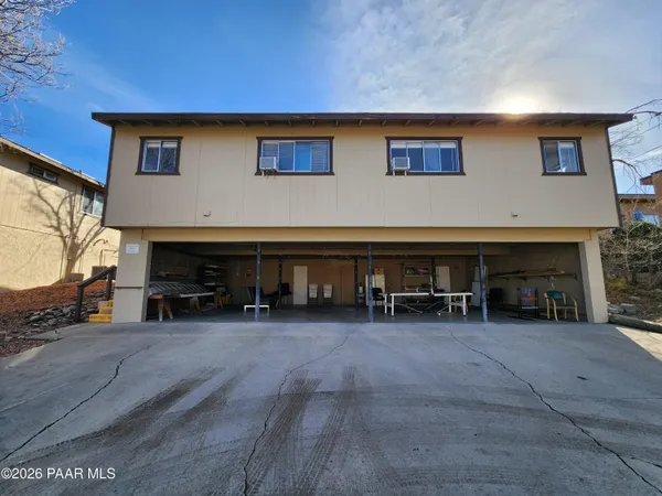 a kitchen with stainless steel appliances granite countertop a stove top oven a sink dishwasher and a refrigerator