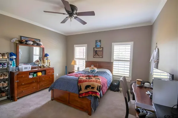 a bedroom with a bed and a tv on dresser