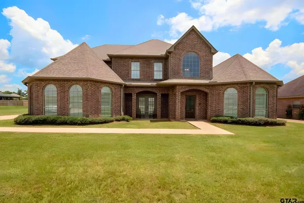 a front view of a house with yard and garage