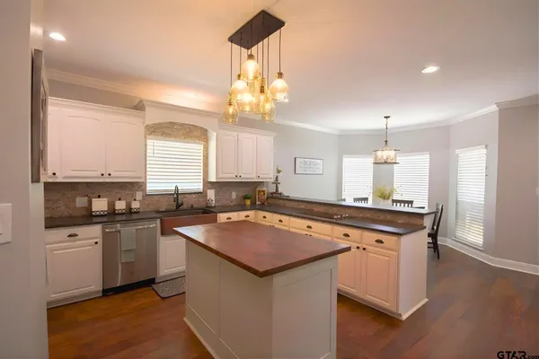 a kitchen with a sink stove and cabinets