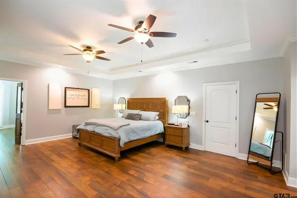 a spacious bedroom with a bed and a chandelier