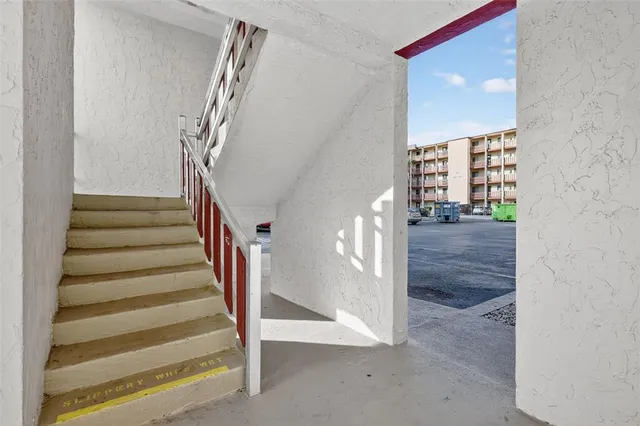 a front view of a house with a yard and a garden