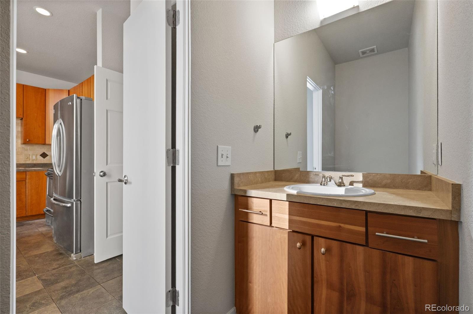 2360 South Wheeling Circle Aurora, CO 80014 - Photo 16 of 31 a bathroom with a granite countertop sink and a mirror