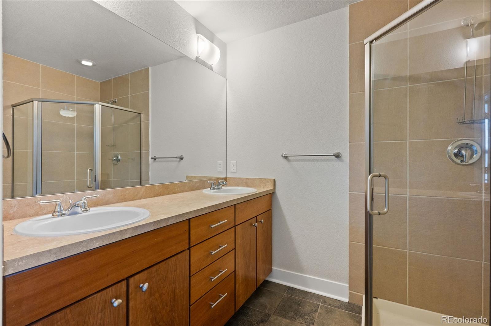 2360 South Wheeling Circle Aurora, CO 80014 - Photo 19 of 31 a bathroom with a granite countertop sink mirror and double