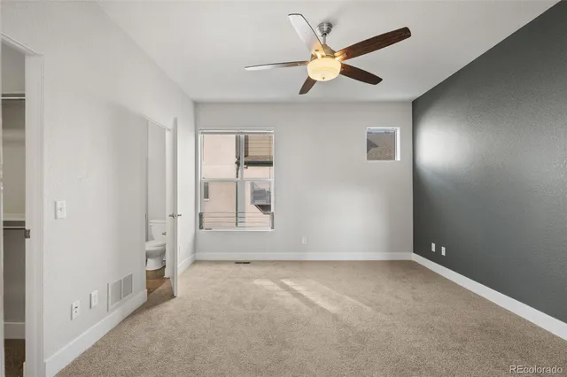 a view of empty room with ceiling fan