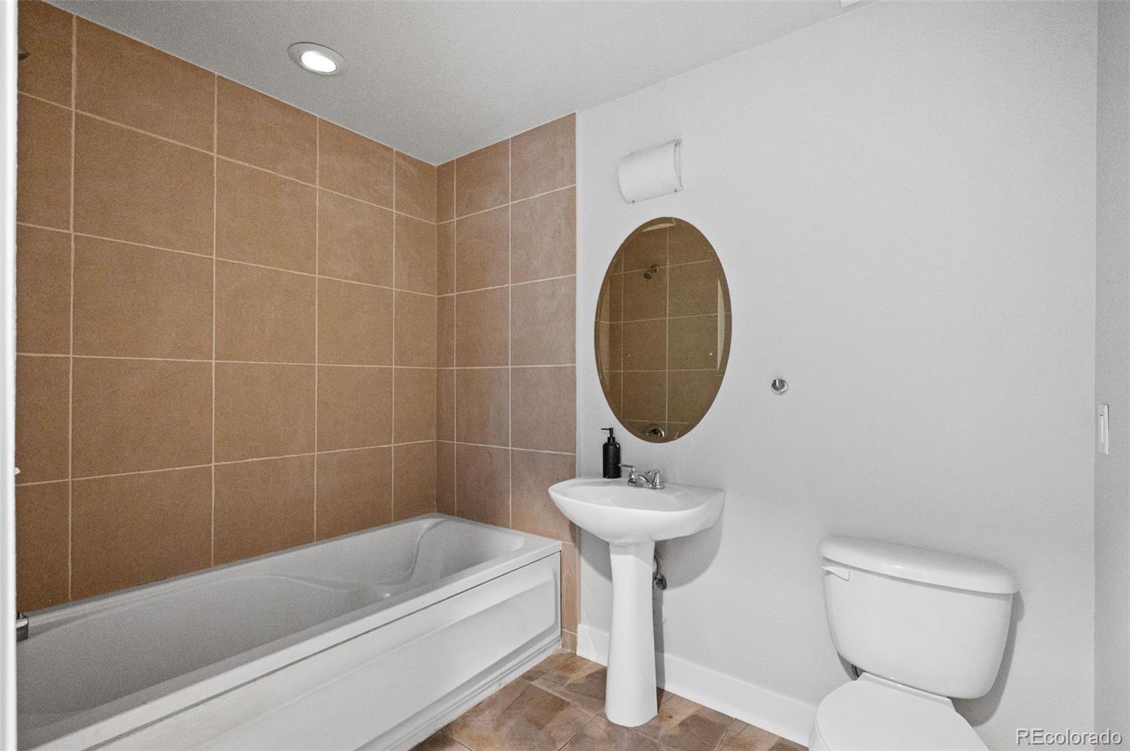 2360 South Wheeling Circle Aurora, CO 80014 - Photo 23 of 31 a bathroom with a toilet a sink and bathtub