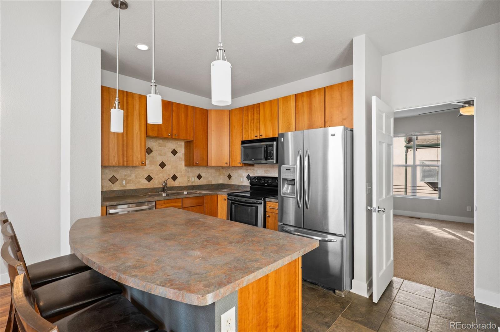 2360 South Wheeling Circle Aurora, CO 80014 - Photo 10 of 31 a kitchen with stainless steel appliances granite countertop a refrigerator a sink a stove and a refrigerator