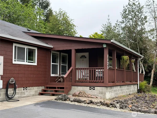 a view of a house with a yard and wooden fence