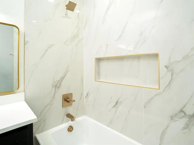 a bathroom with a bathtub and a sink