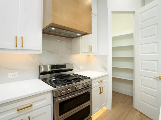 a kitchen with a refrigerator and a sink