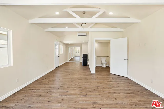 a view of an empty room and wooden floor