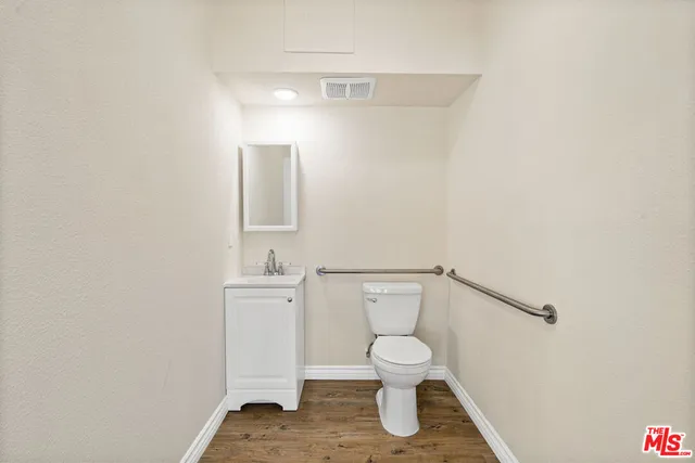 a white toilet sitting next to a sink