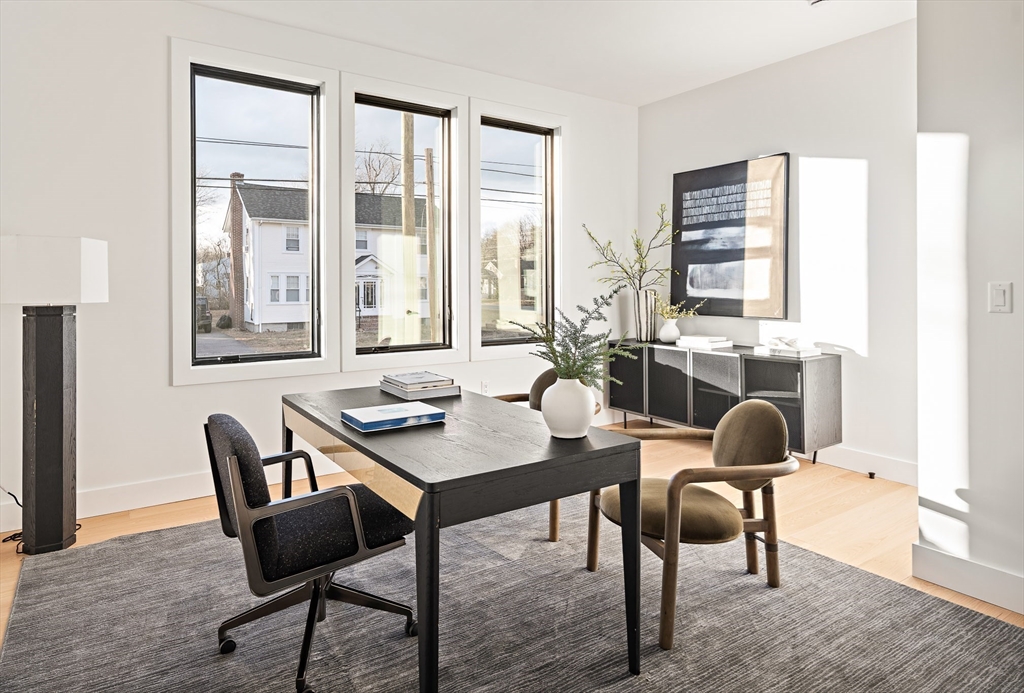 27 2nd Street Natick, MA 01760 - Photo 14 of 39 a view of a workspace with furniture and a window