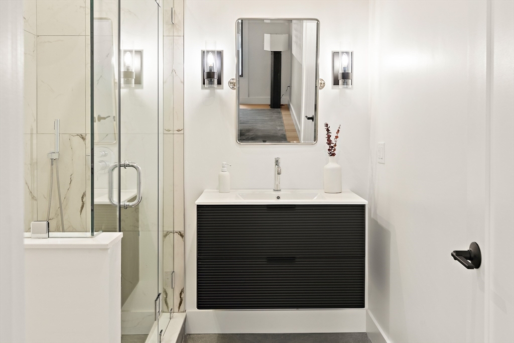 27 2nd Street Natick, MA 01760 - Photo 15 of 39 a bathroom with a sink and a mirror