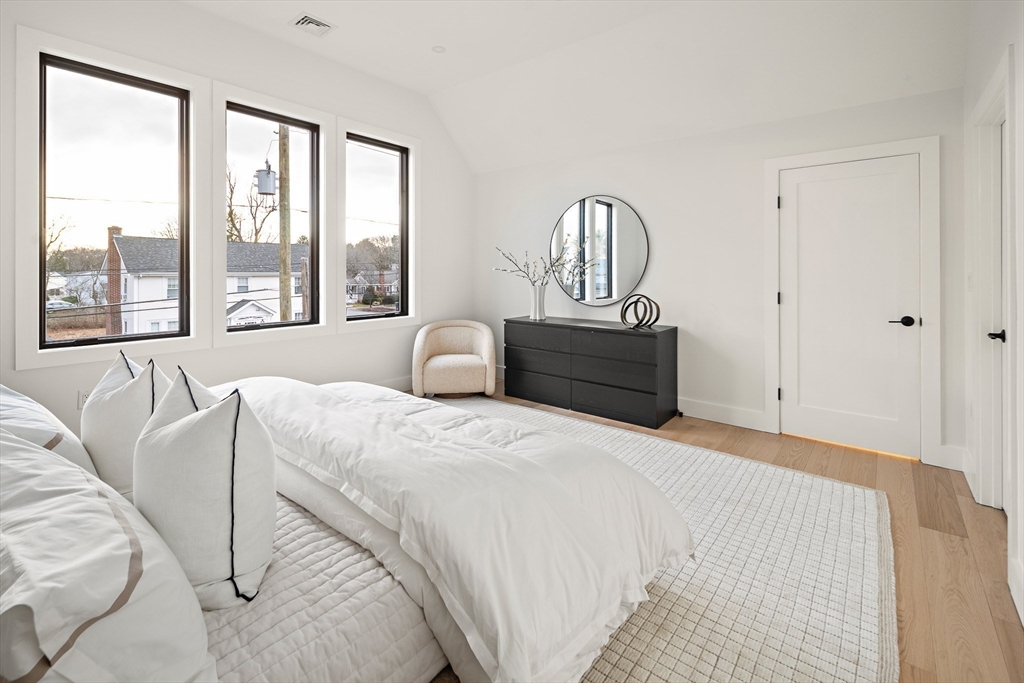 27 2nd Street Natick, MA 01760 - Photo 18 of 39 a bedroom with bed and a large window