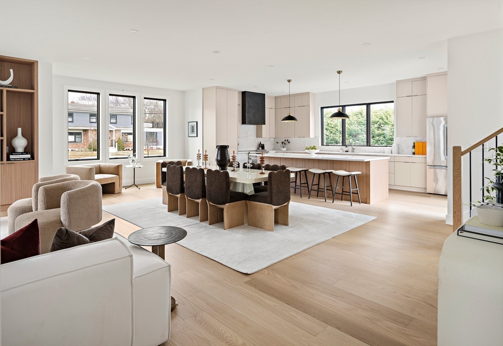 27 2nd Street Natick, MA 01760 - Photo 2 of 39 a living room with furniture a large window and wooden floor