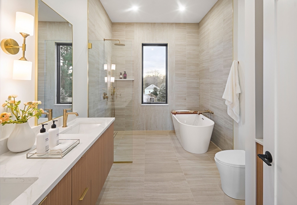 27 2nd Street Natick, MA 01760 - Photo 21 of 39 a bathroom with a granite countertop sink a toilet a mirror and bathtub