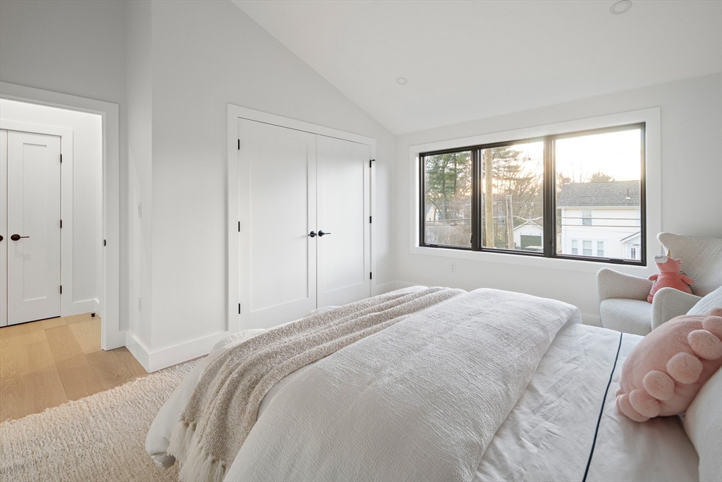 27 2nd Street Natick, MA 01760 - Photo 26 of 39 a spacious bedroom with a bed and a large window