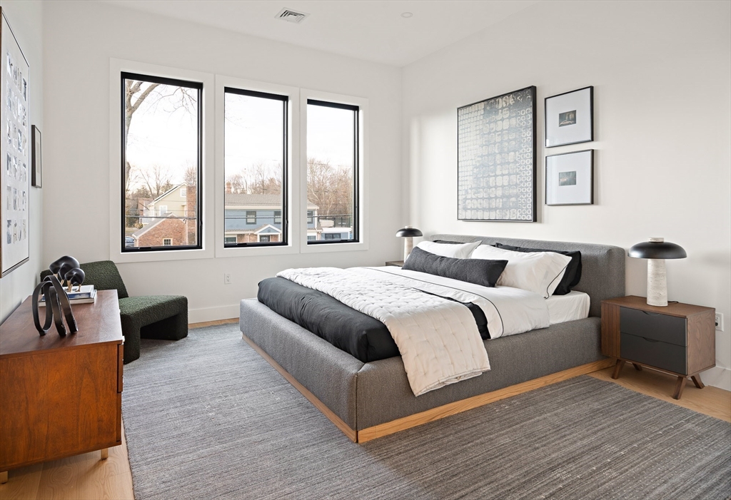 27 2nd Street Natick, MA 01760 - Photo 28 of 39 a spacious bedroom with a bed couch and a large window
