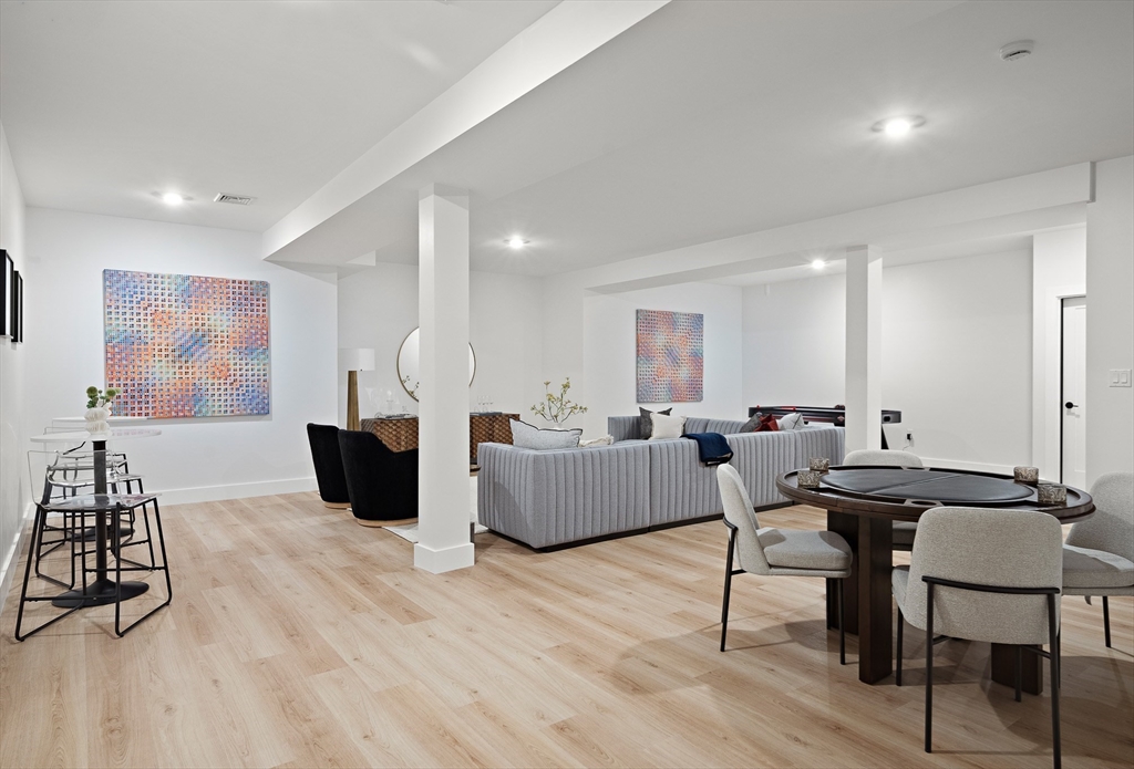 27 2nd Street Natick, MA 01760 - Photo 31 of 39 a living room with furniture a wooden floor and a flat screen tv