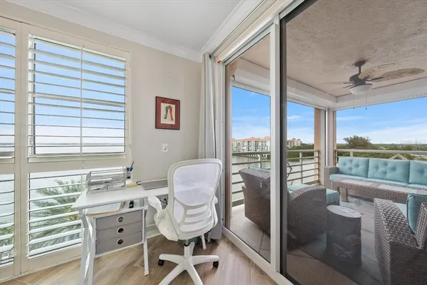 a roof deck with couches and potted plants