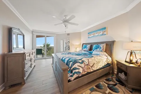 a bedroom with a large bed and a mirror on dresser
