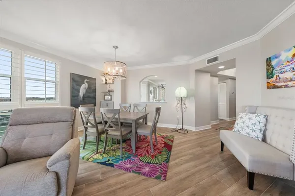 a kitchen with granite countertop lots of white cabinets and wooden floor