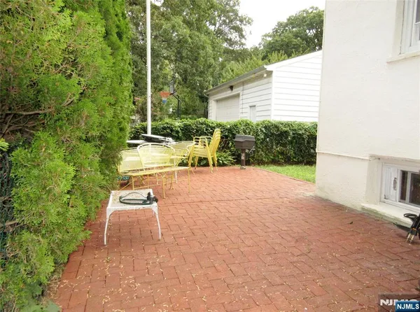 a view of backyard with outdoor seating and plants