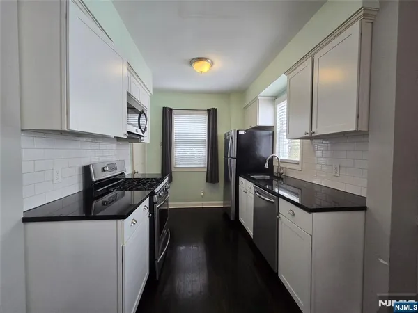 a kitchen with a sink stove and refrigerator