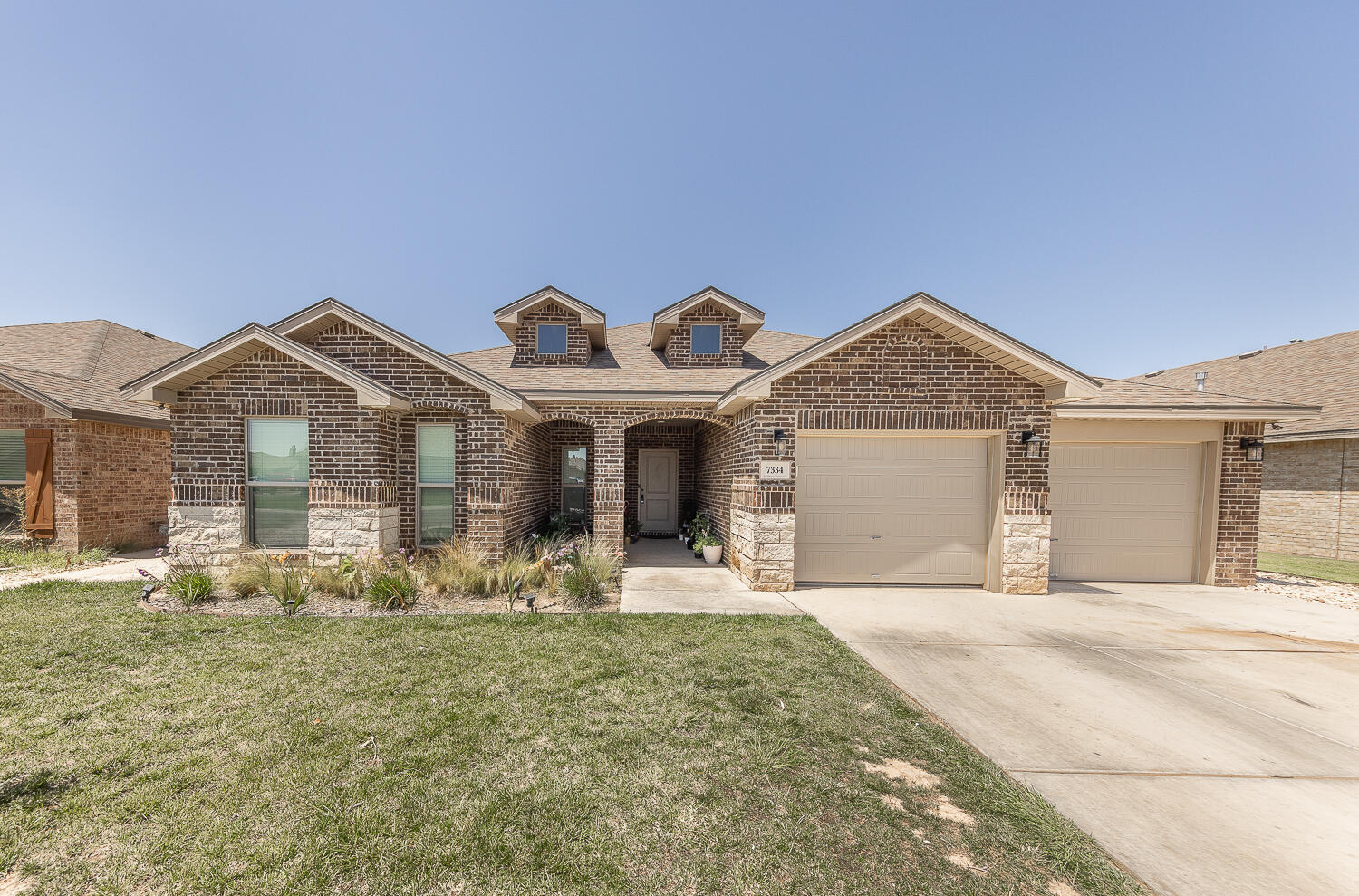 7334 29th Street Lubbock, TX 79407 - Photo 1 of 31 a front view of a house with garden