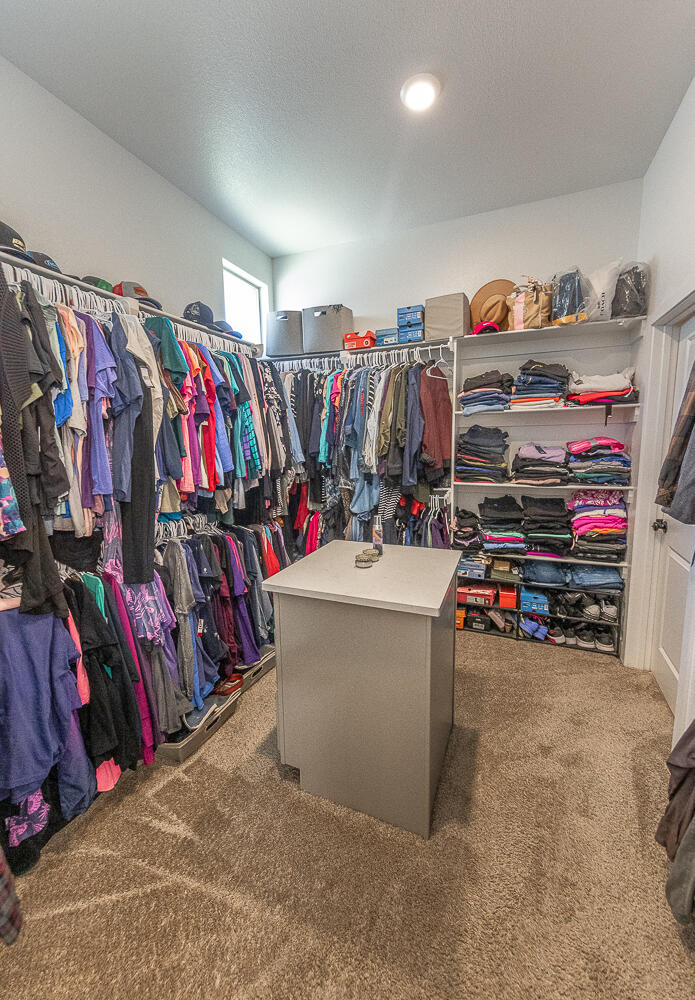 7334 29th Street Lubbock, TX 79407 - Photo 12 of 31 a view of walk in closet with clothes