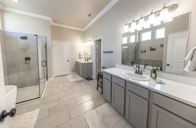 a bathroom with a sink a toilet and shower