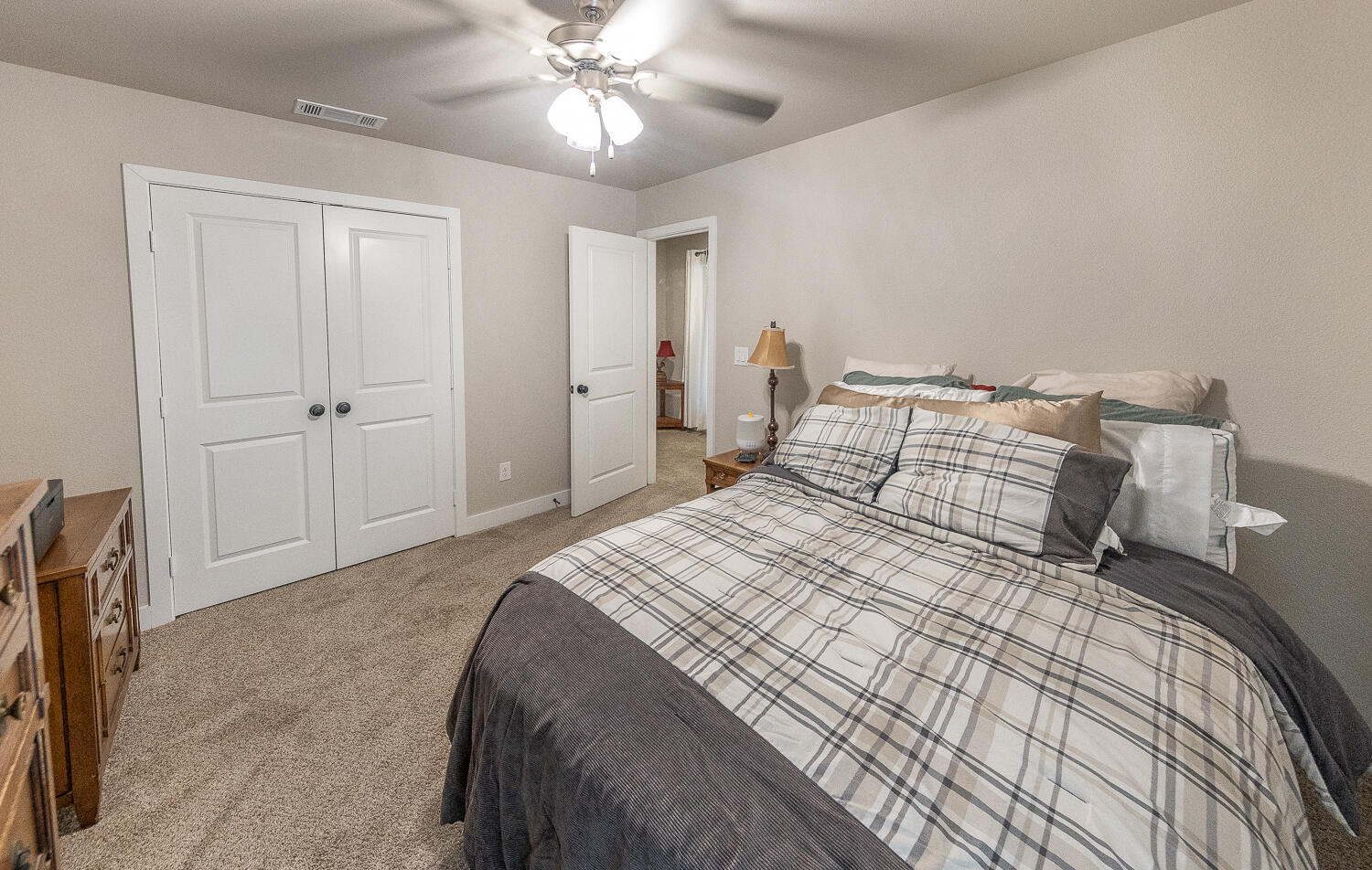7334 29th Street Lubbock, TX 79407 - Photo 20 of 31 a bedroom with a large bed and a chandelier