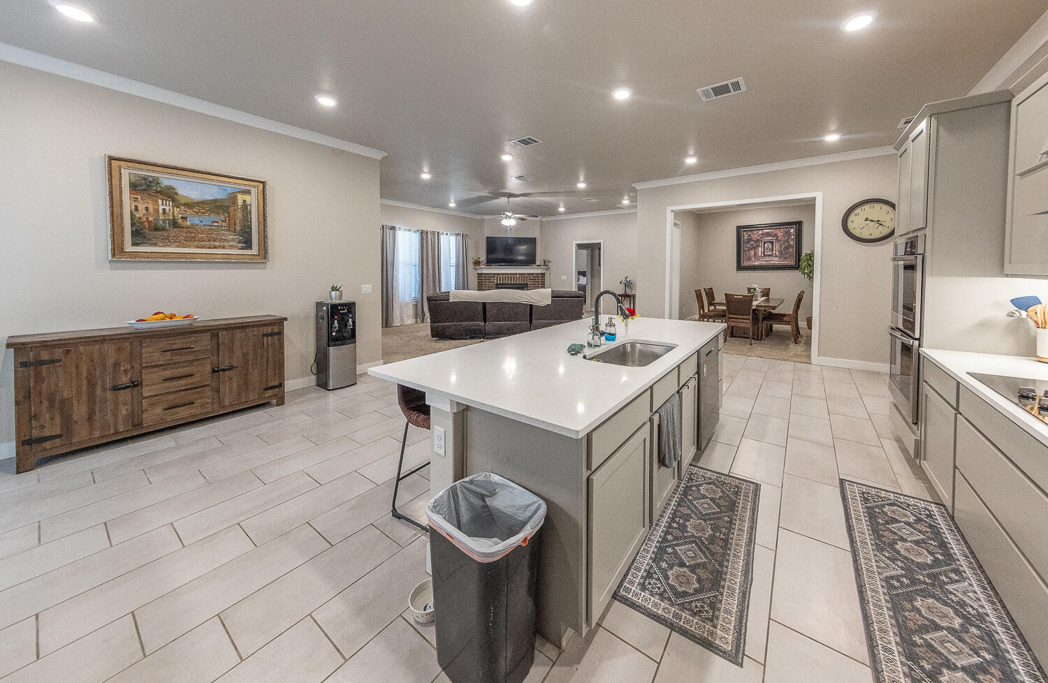 7334 29th Street Lubbock, TX 79407 - Photo 28 of 31 a large kitchen with kitchen island a sink a counter space and stainless steel appliances