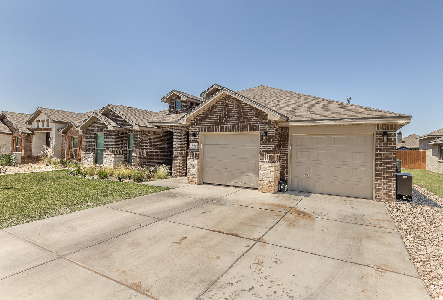 7334 29th Street Lubbock, TX 79407 - Photo 30 of 31 a front view of a house with a garden and pathway