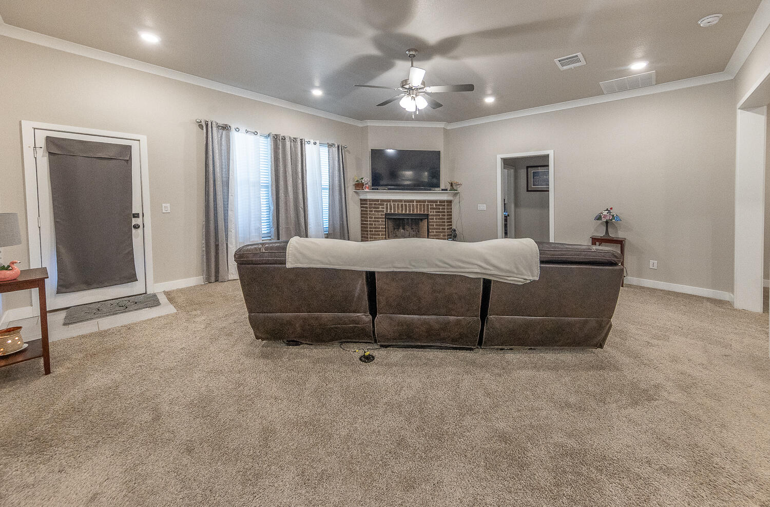 7334 29th Street Lubbock, TX 79407 - Photo 4 of 31 a living room with furniture and a ceiling fan