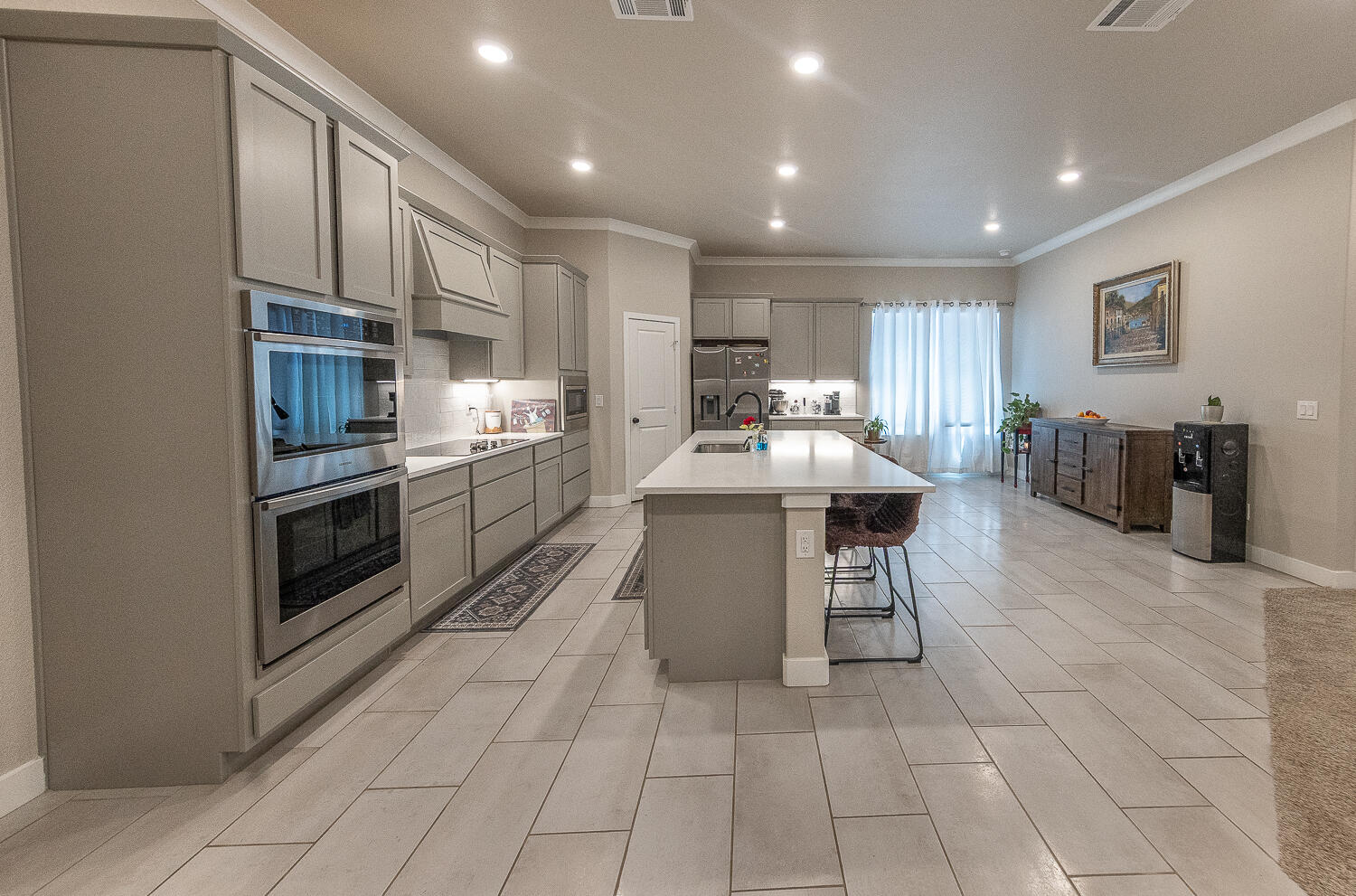 7334 29th Street Lubbock, TX 79407 - Photo 9 of 31 a kitchen with stainless steel appliances a stove a sink a oven a dining table and chairs