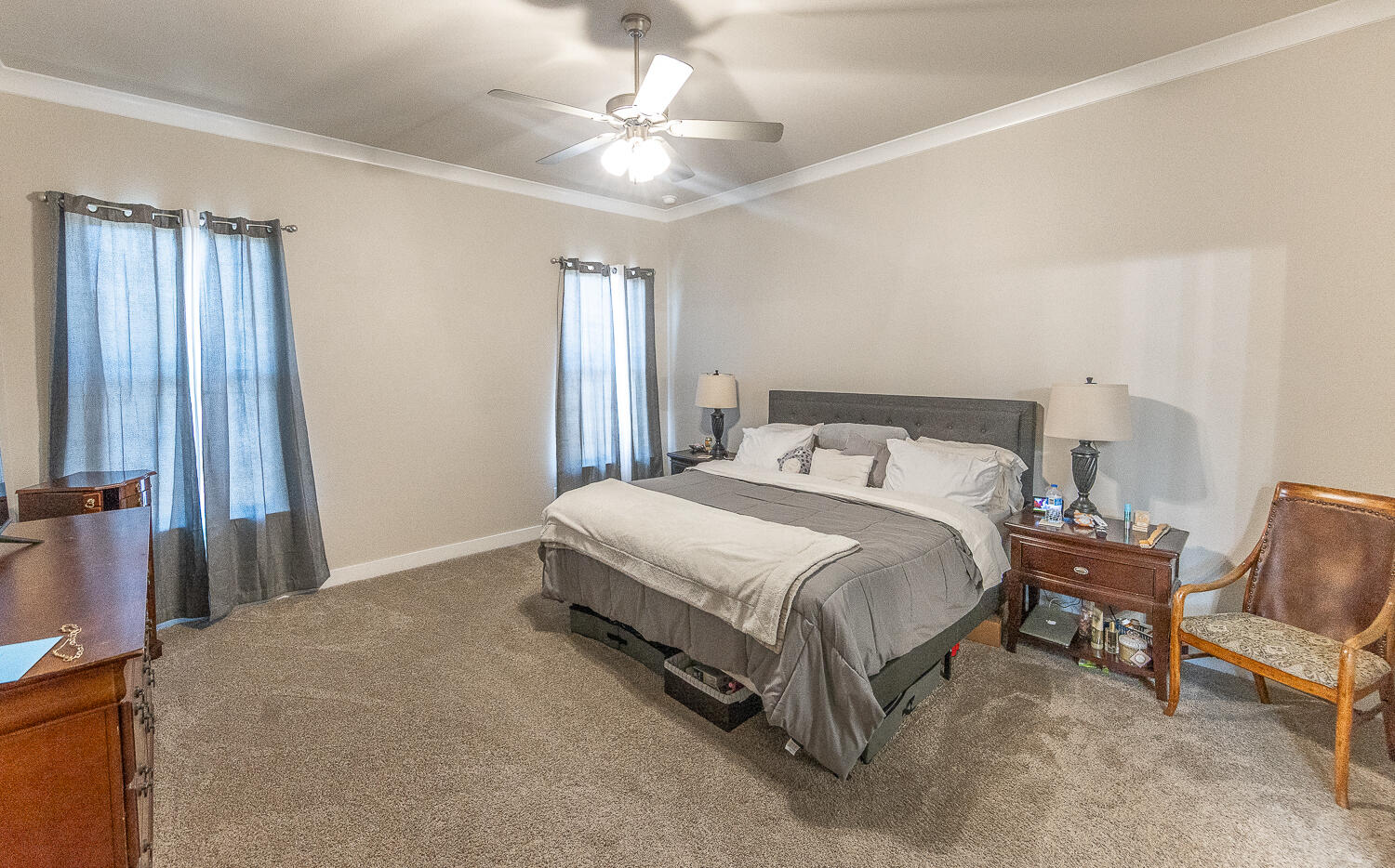 7334 29th Street Lubbock, TX 79407 - Photo 10 of 31 a bedroom with a bed chair and window