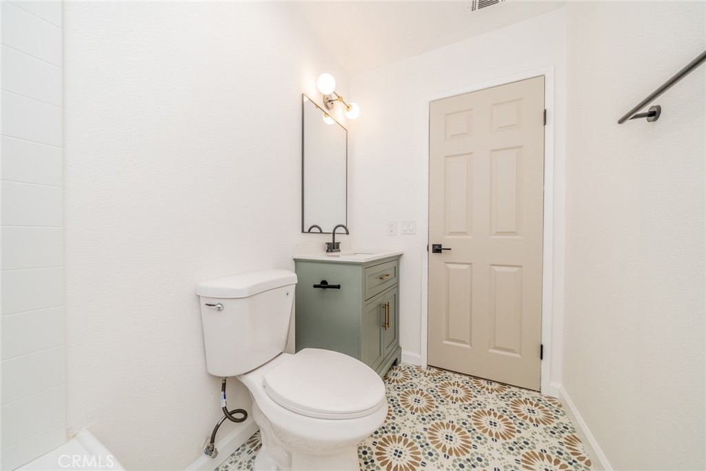 555 North Chestnut Avenue Rialto, CA 92376 - Photo 21 of 33 a bathroom with a sink a toilet and shower