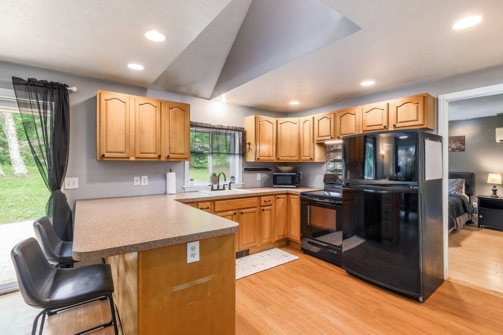 10 Bernie Road Holland, MA 01521 - Photo 3 of 29 a kitchen with stainless steel appliances granite countertop a refrigerator sink and cabinets