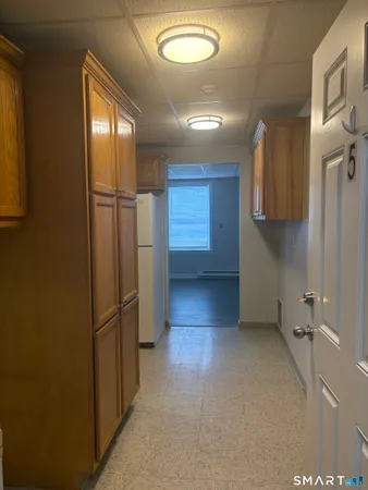 a view of a hallway with seating area