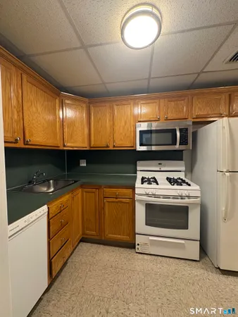 a kitchen with stainless steel appliances a stove a sink and a microwave