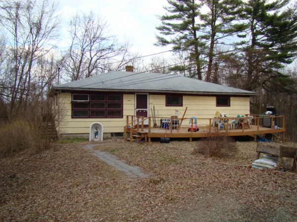255 Putnam Hill Road Sutton, MA 01590 - Photo 1 of 6 a front view of a house with garden