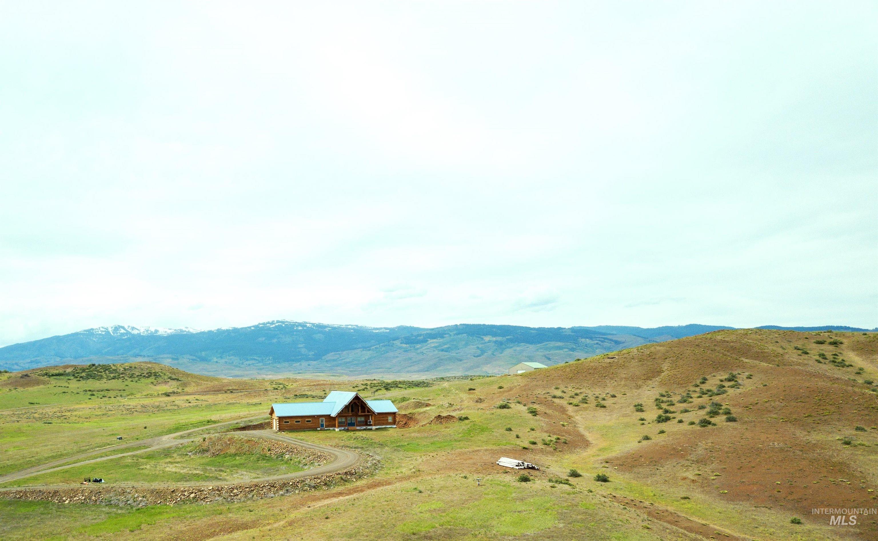 View of mountain backdrop featuring rural landscape