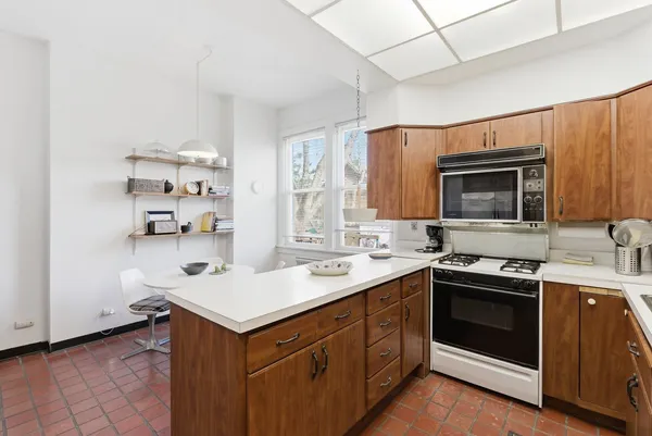 a kitchen with a sink stove top oven and cabinets