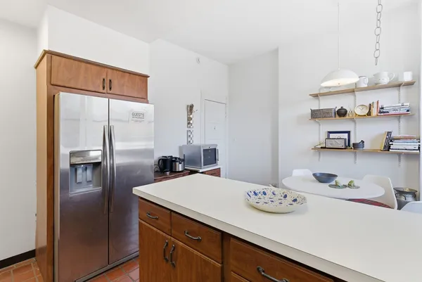 a kitchen with stainless steel appliances a refrigerator and a stove